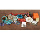 A collection of costume jewels, including a turquoise bead necklace, copal pebble necklace,