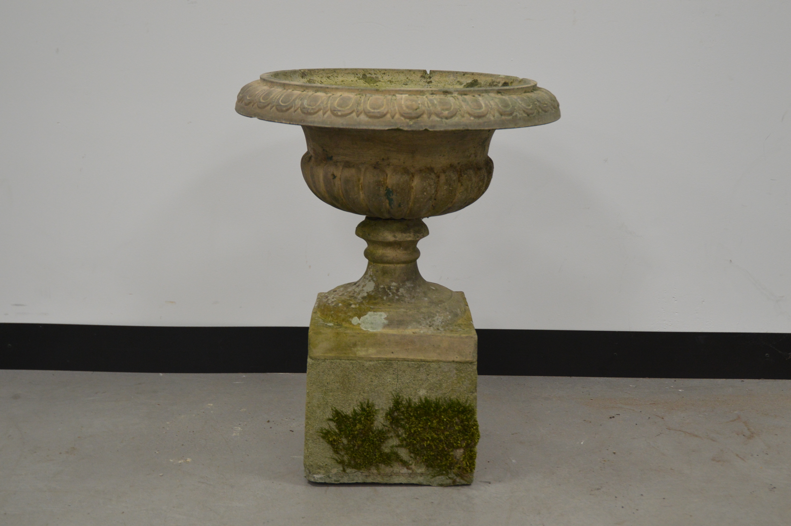 A neo classical style garden planter on square base, cast decoration. 63 cm tall. In two parts. Some