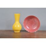 A Ruskin bowl with lustre glaze, marked to the underside, together with a yellow-glazed vase. Both