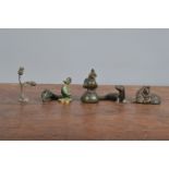 A collection of cast metal figurines, mostly animals, comprising a seal, dolphin, a duck on a