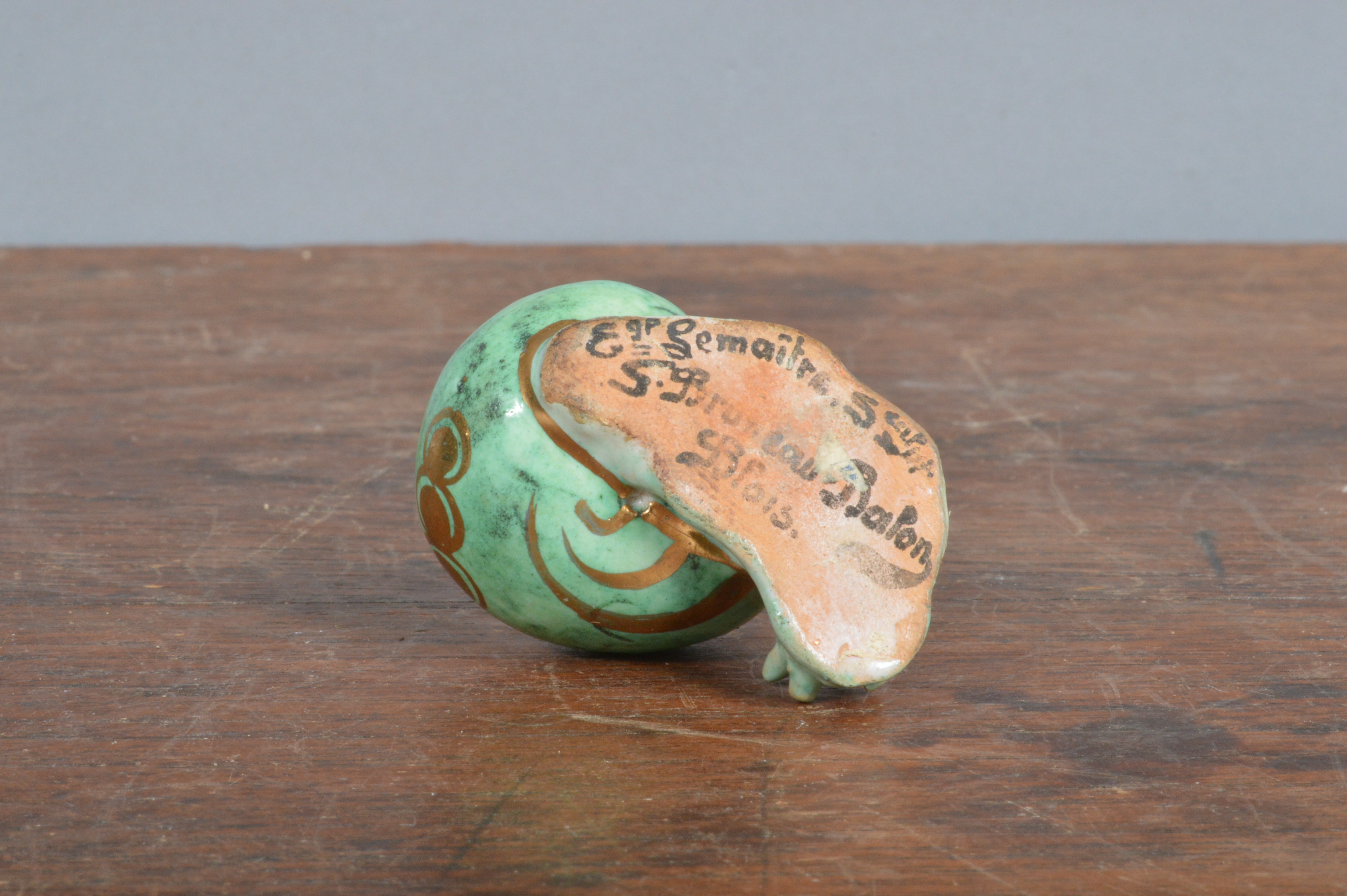 An early 20th century French Bruneau Balon Blois faience snail, green glaze with heightened gilt, - Image 3 of 3