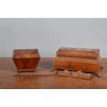 A small Regency rosewood and mahogany veneered tea caddy, the lid missing raised on bun feet, 9cm