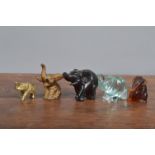 Five small Elephant figurines, comprising amber, gilt spelter, brass, glass and wood examples, of