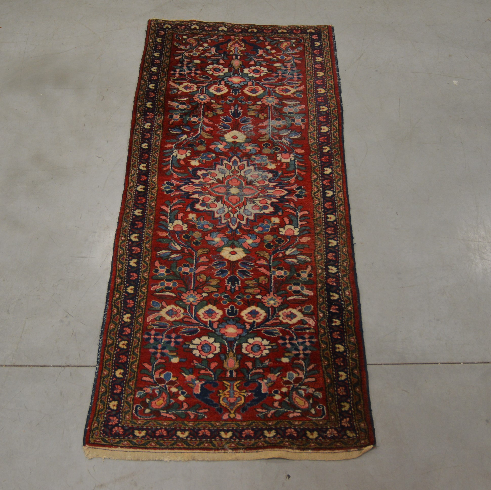 A modern Iranian wool runner, floral geometric pattern, with some wear 200cm x 87cm