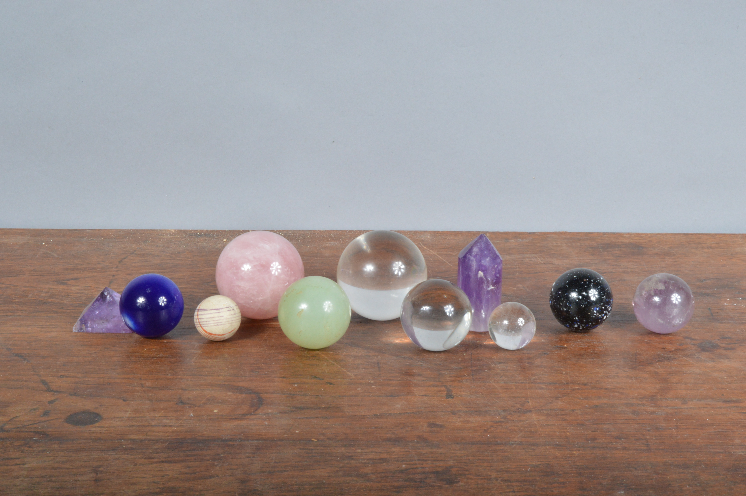 A collection of rock crystal, and glass spherical balls and other items, ranging from 5.5cm to 2.5cm