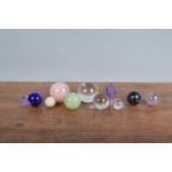 A collection of rock crystal, and glass spherical balls and other items, ranging from 5.5cm to 2.5cm