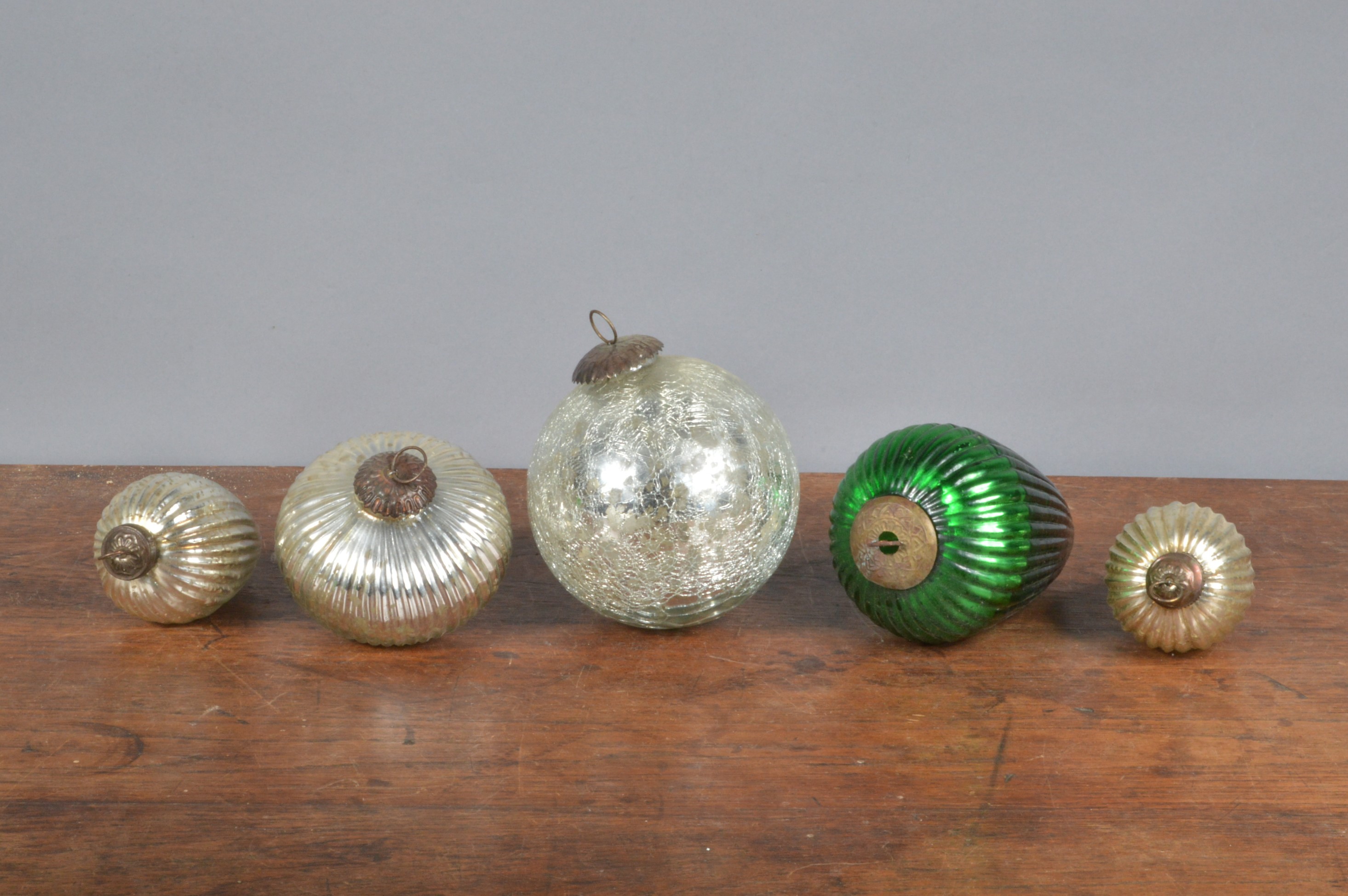 A group of late 19th/ early 20th century baubles, each of moulded form with mercury glass interior