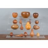 A collection of 20th century carved wooden fruit, depicting, apples, pears, eggs, and others,