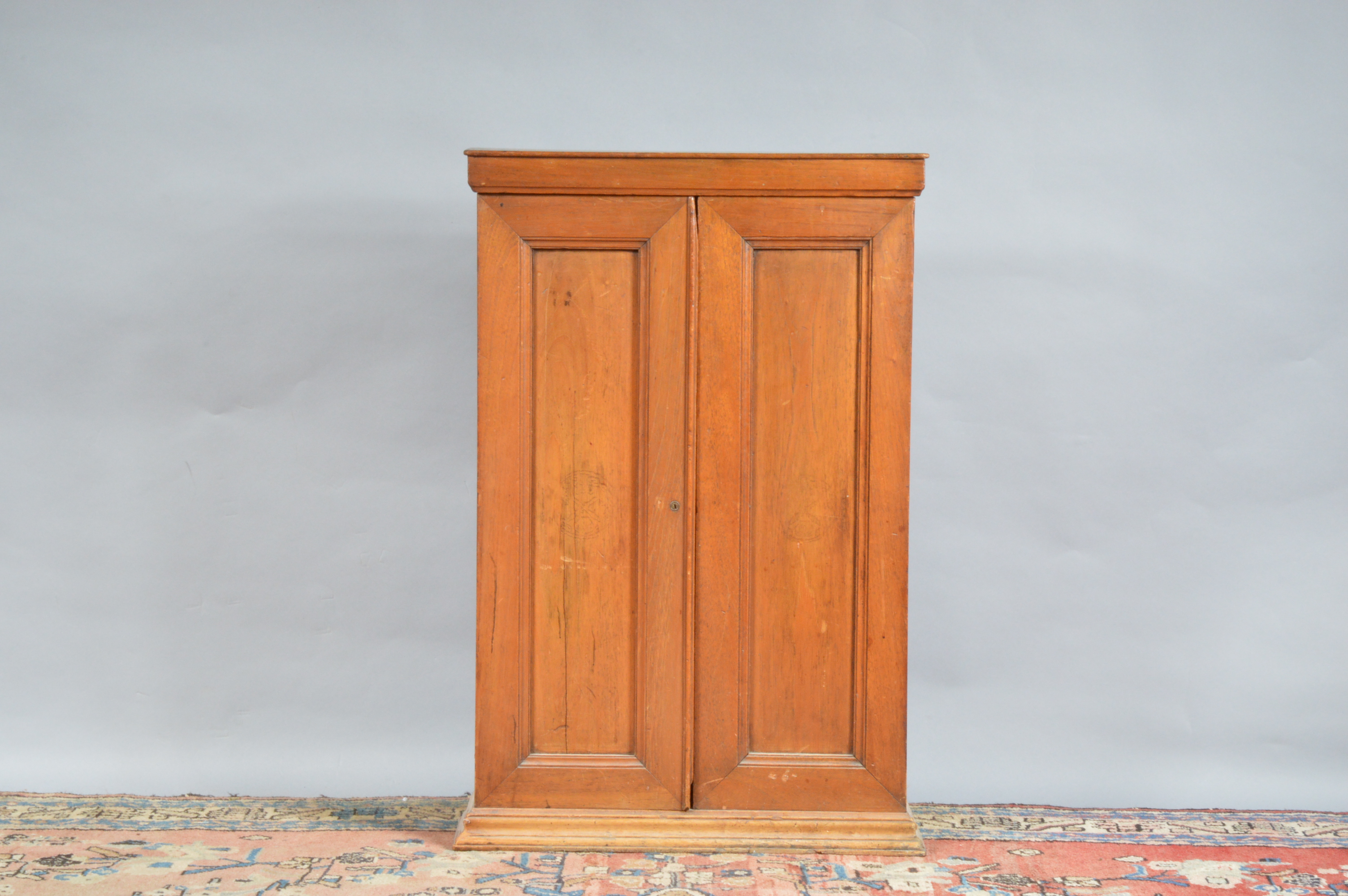 An early 20th century oak cabinet, possibly from a shop, two cupboard doors enclosing five