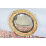 A 19th century convex mirror, worn gilt wooden frame, with ebonised slip, AF 65cm diameter