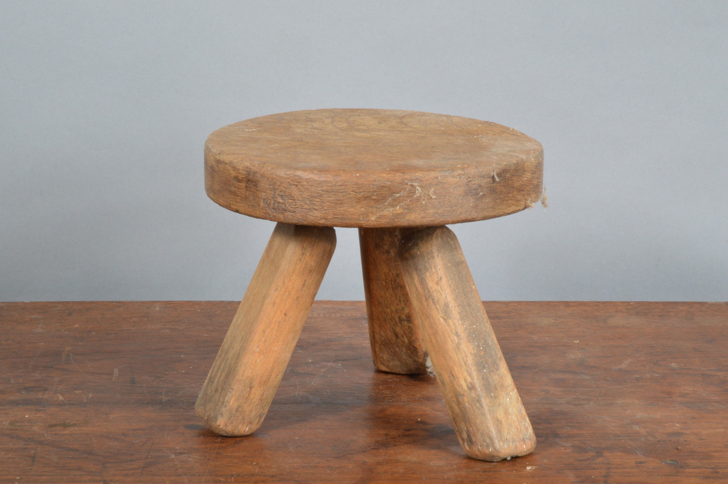 A 19th century primitive small oak stool, circular top with three supports, 15.5cm H x 18cm W