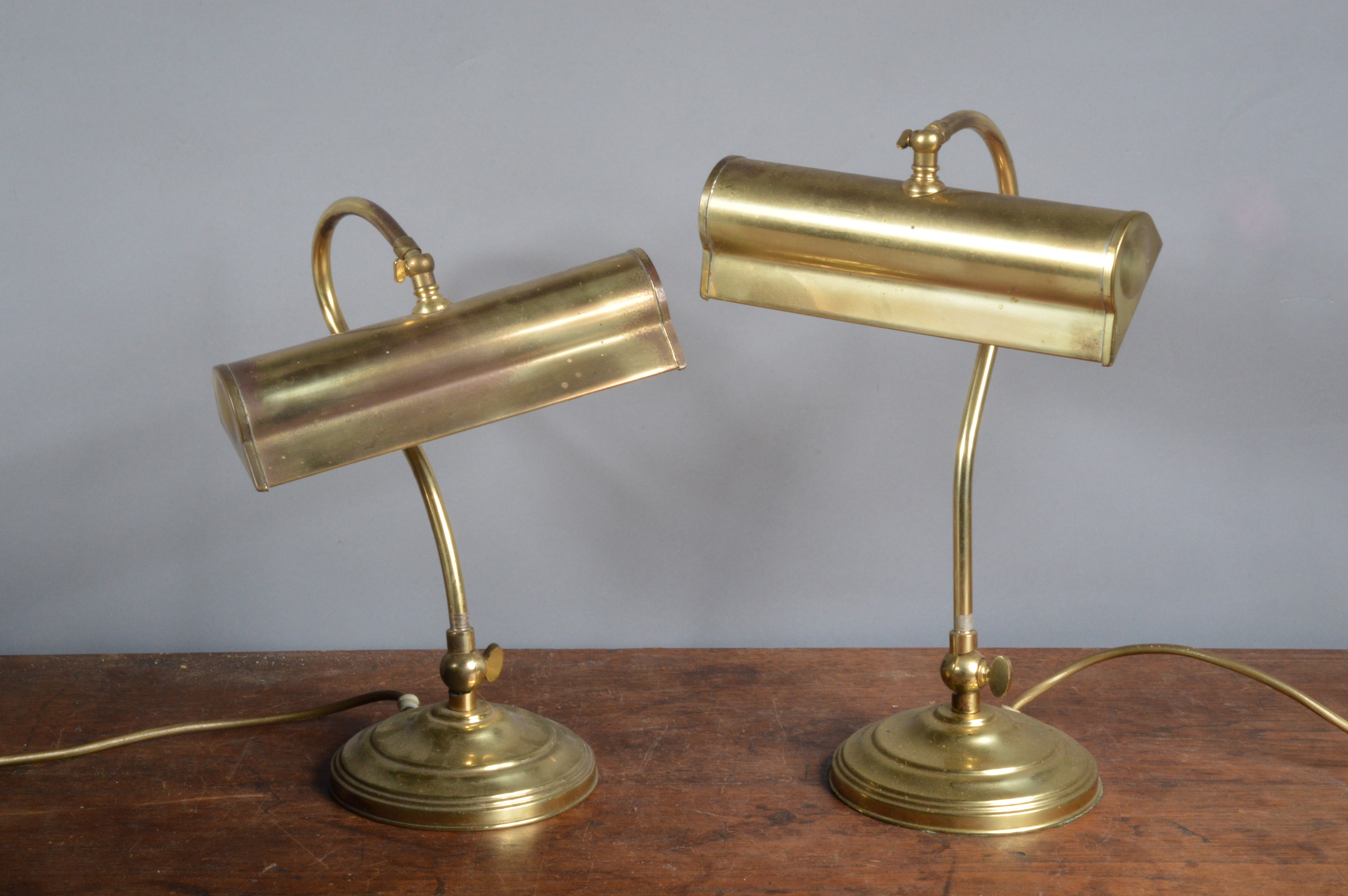 Two brass mid-century table library lights, by Christopher Wray of London, 36 cm tall, one still