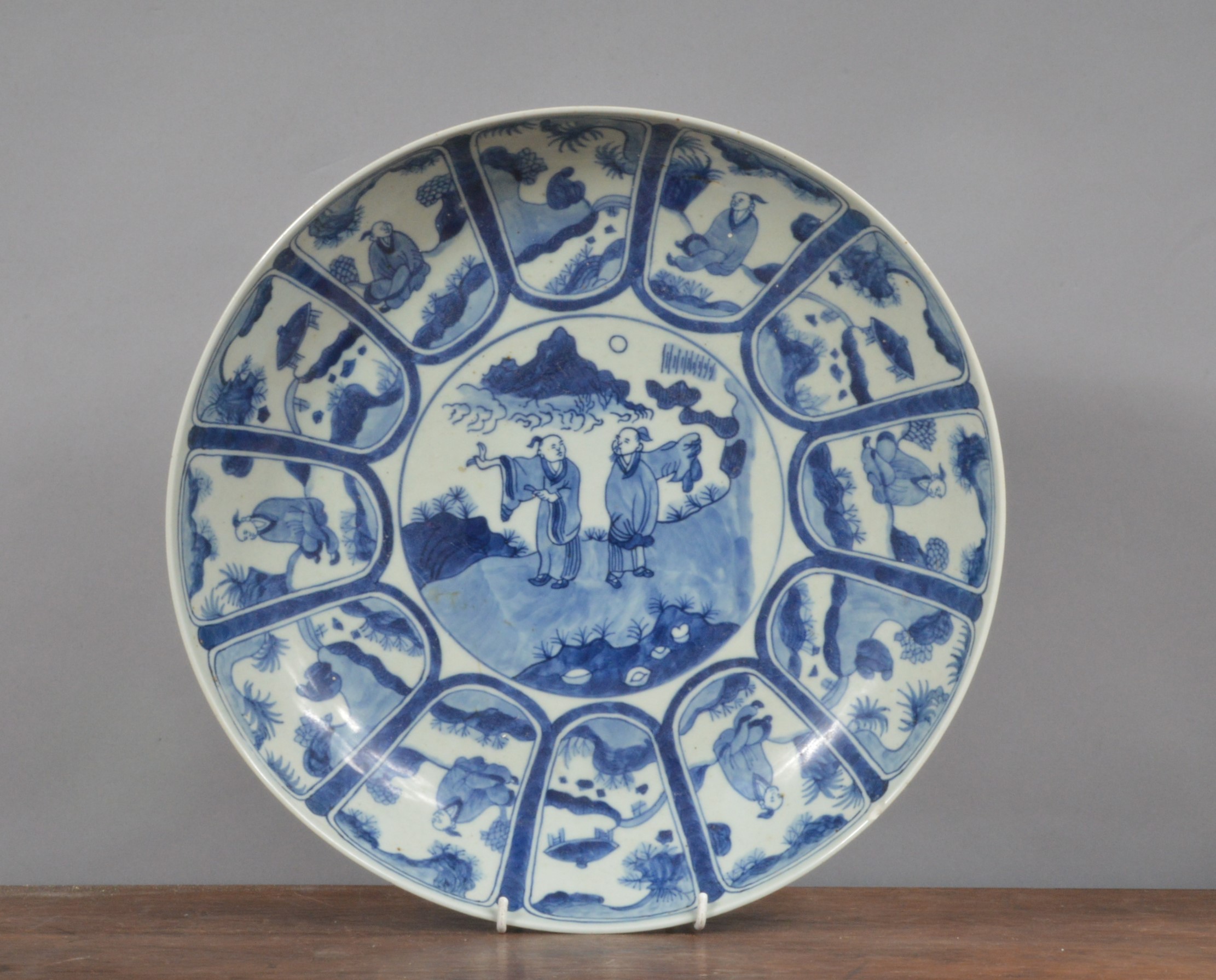 A 19th century Chinese blue and white hand-painted large charger, decorated with a central scene