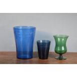 A large blue glass vase/waste paper bin, 33cm high, together with a green glass footed vase, 24cm