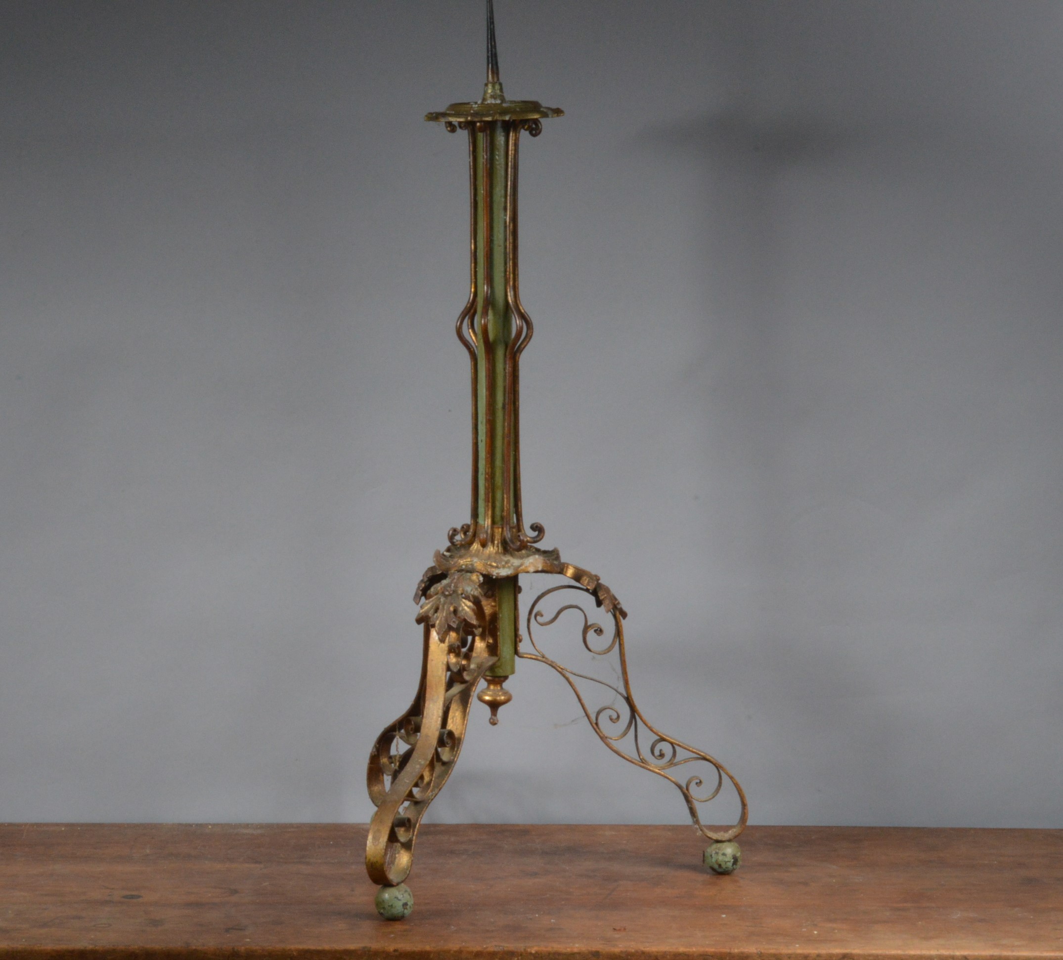 A 19th century Continental gilt metal and hand-painted candle stand, with plaster column mounted