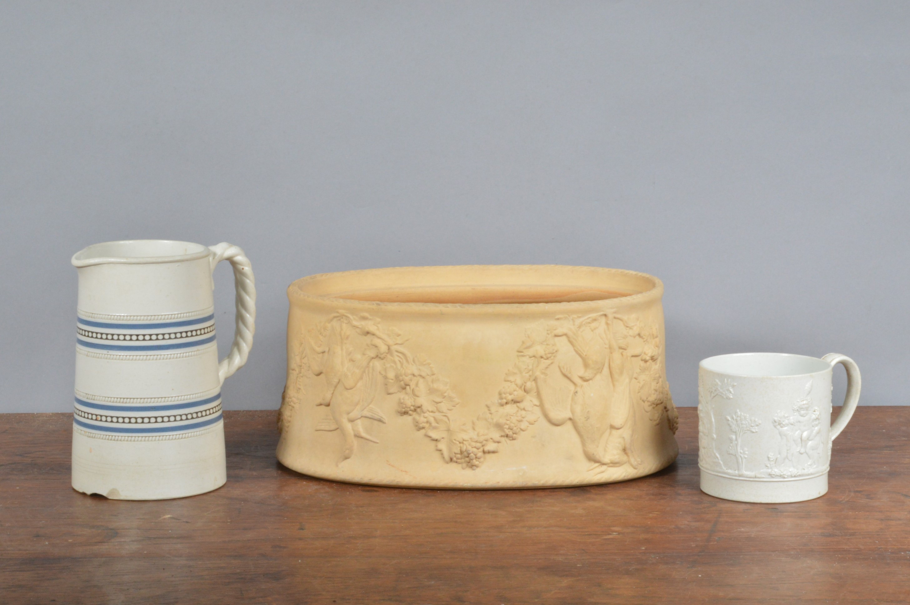 A 19th century Wedgwood caneware game dish, together with a Wedgwood feldspathic sprig moulded mug