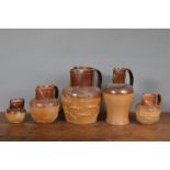 A selection of 19th century brown stoneware jugs, each sprig moulded with tavern and hunting scenes.