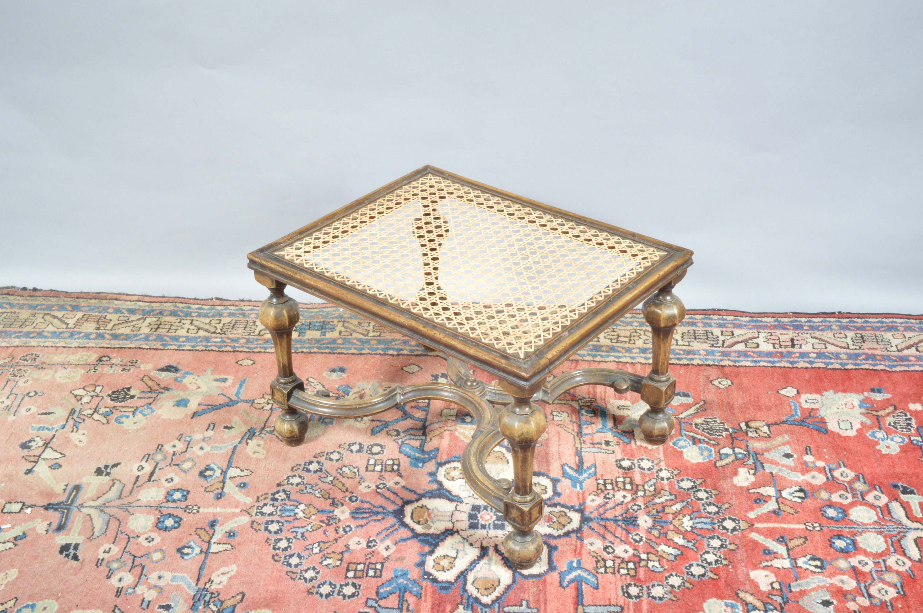 A 19th century continental possibly Italian footstool, newly caned top, raised on four turned - Image 3 of 3