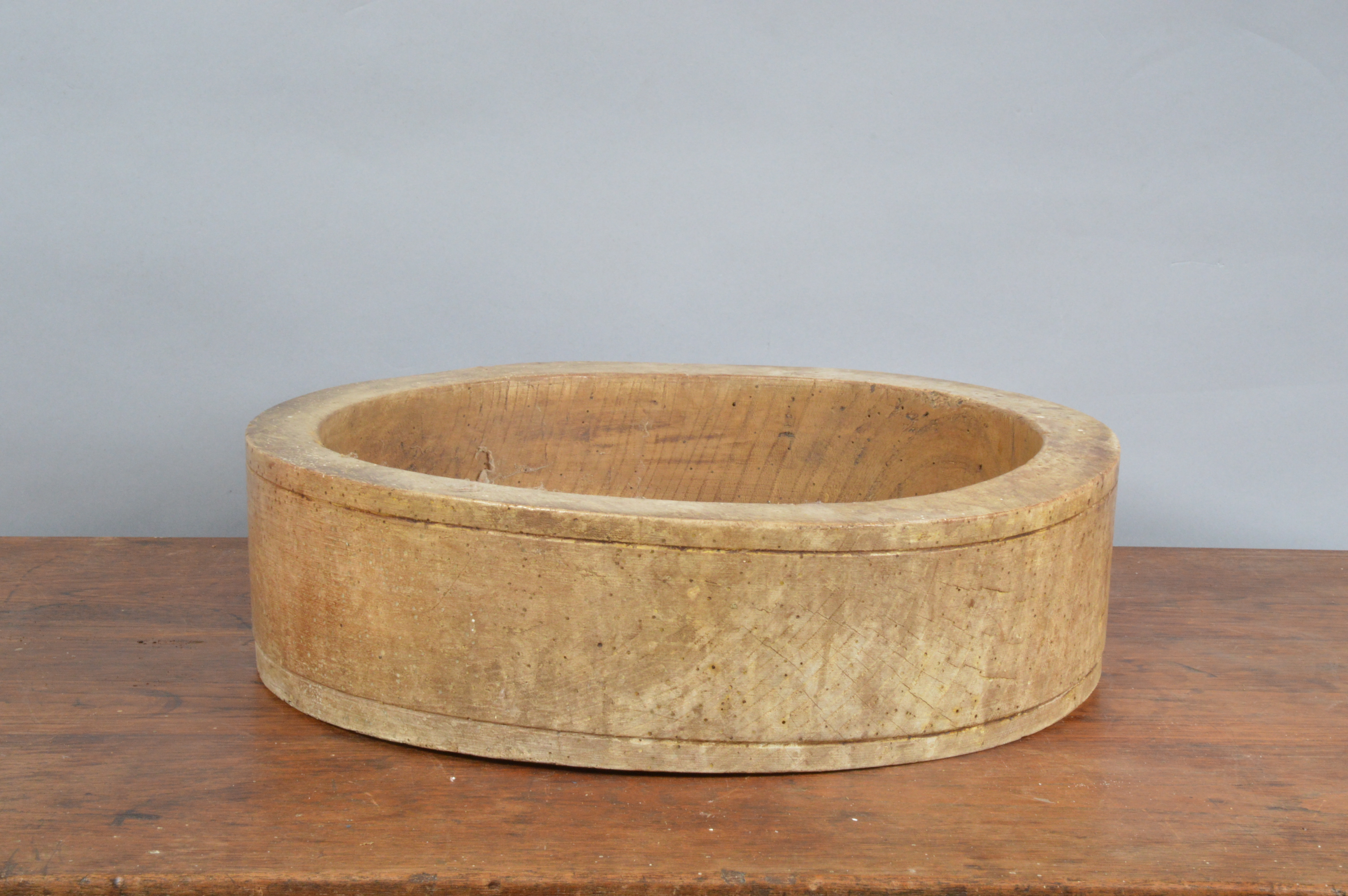 A large 19th century elm primitive treen straight sided bowl, with historic woodworm and other