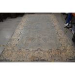 A very large Modern wool carpet, blue central ground with ivory border, some staining and moth