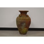 A terracotta amphora shaped garden urn, with incised geometric decoration of flowers. 70 cm tall.