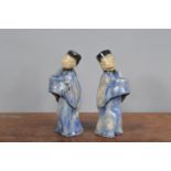 A pair of early 20th century Chinese ceramic figurines, possibly for offerings, crazing to the glaze