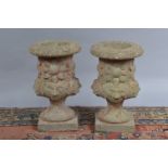 A pair of short concrete planters, in the classical style, both approx. 34 cm tall (2)