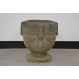 A cast stone planter in the neoclassical style, decorated with grapes, 40 cm tall. Some wear and