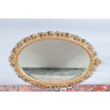 A 19th century and later oval gilt gesso mirror, re-painted, some damage, later bevelled mirror