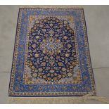 A silk on cotton rug, bold blue geometric pattern, one end with a larger fringe 155cm x 110cm