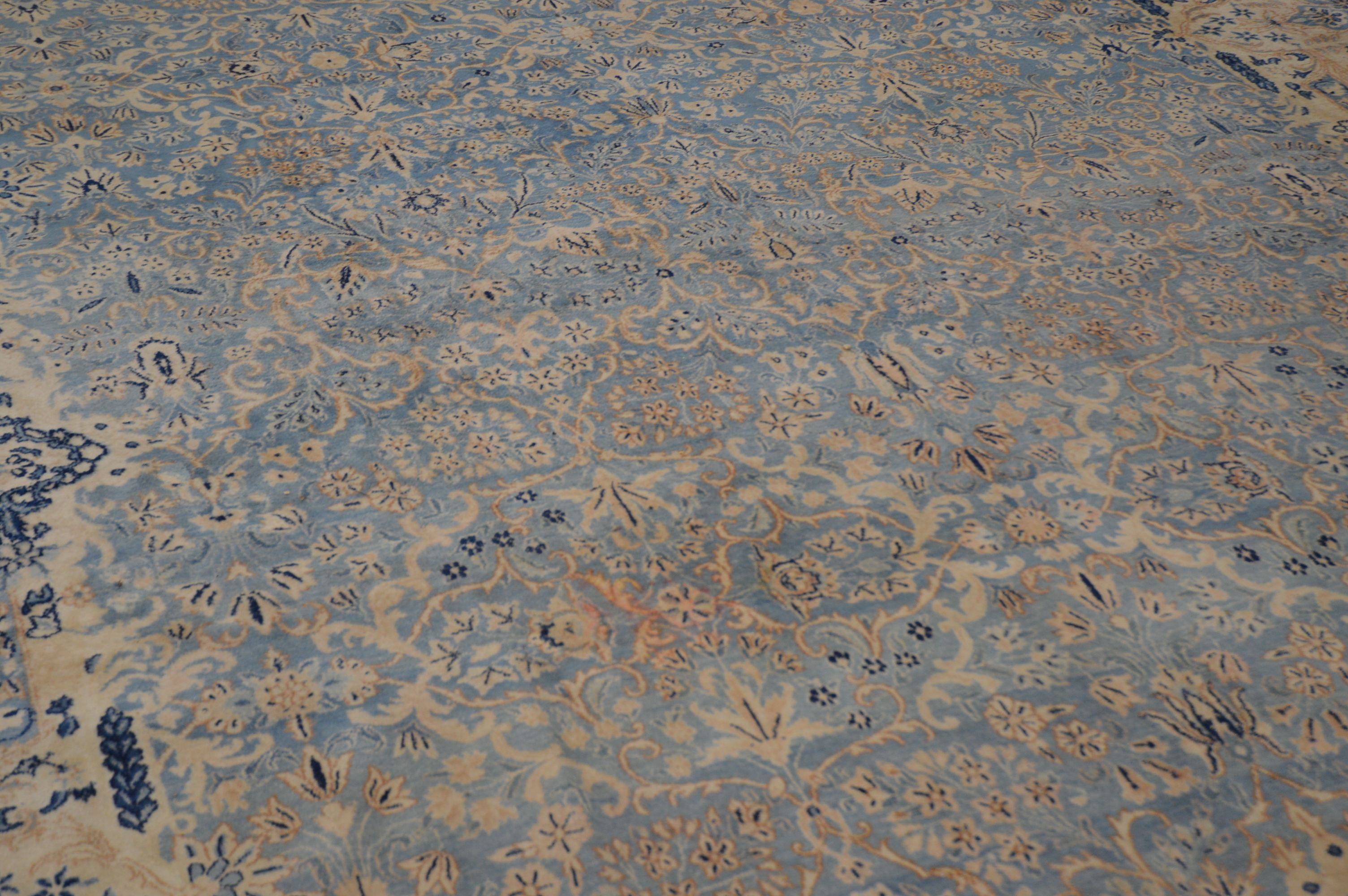 A very large Modern wool carpet, blue central ground with ivory border, some staining and moth - Image 2 of 4