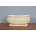 A Fulham Pottery boat-shaped planter, with glazed interior and impressed marks to base. 27 cm