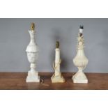 Three 19th century alabaster table lamps, all with carved columns, and square bases, tallest 51.5cm