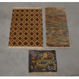 Three assorted rugs, comprising a geometric example 90cm x 62cm, and a striped example and