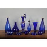 An assorted collection of Bristol Blue glass, 19th century and later, including a claret jug with