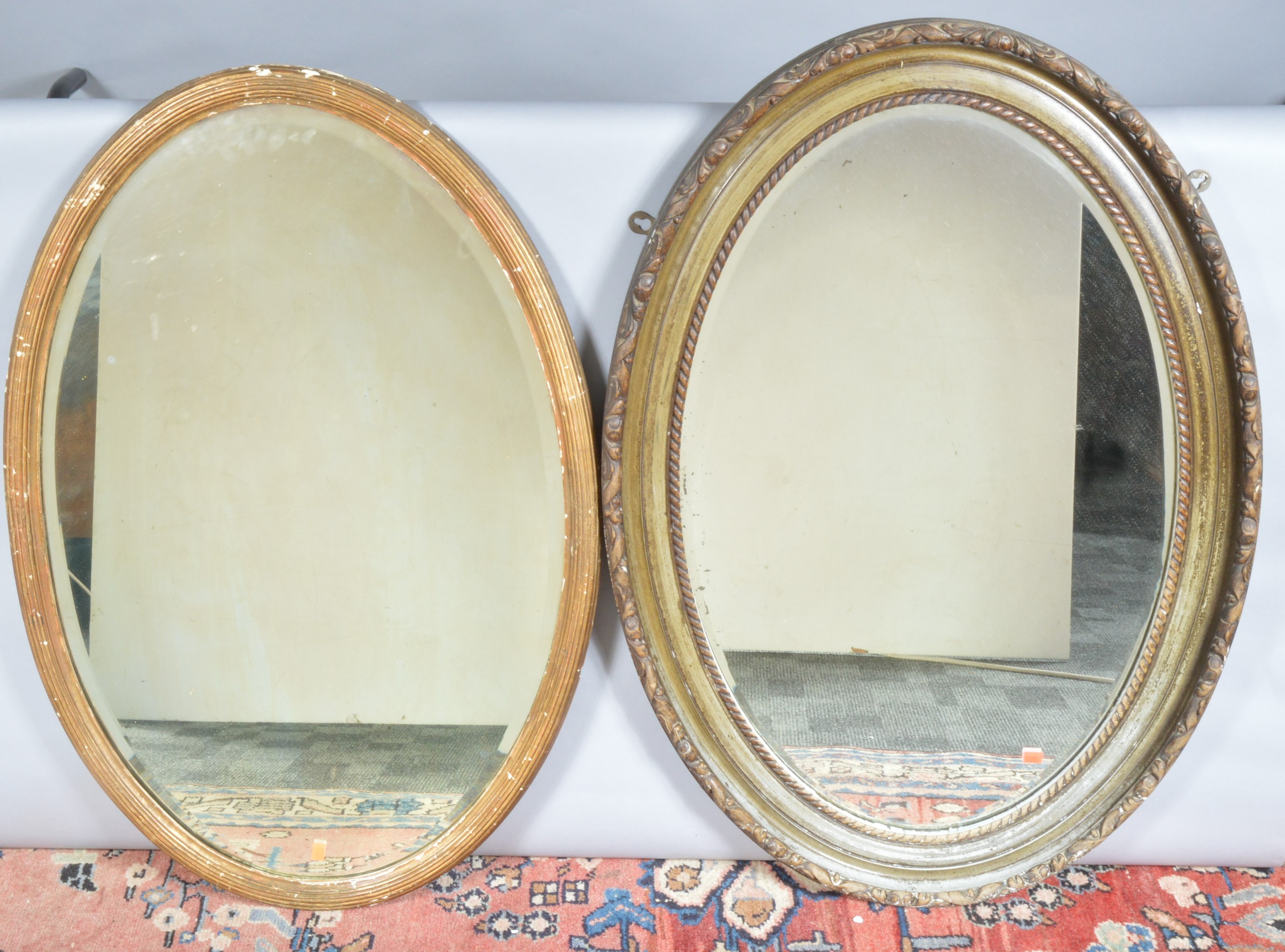 Two oval mirrors, one giltwood, the other painted (worn), both with bevelled mirror plates, AF