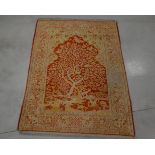 A wool on cotton prayer rug, depicting the tree of life, on a red ground, some wear and minor