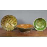 A 19th century French dairy bowl, together with a treacle-glazed bowl with stylised floral