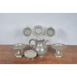 A collection of late 18th century and later pewter kitchen items, comprising a toast water jug,