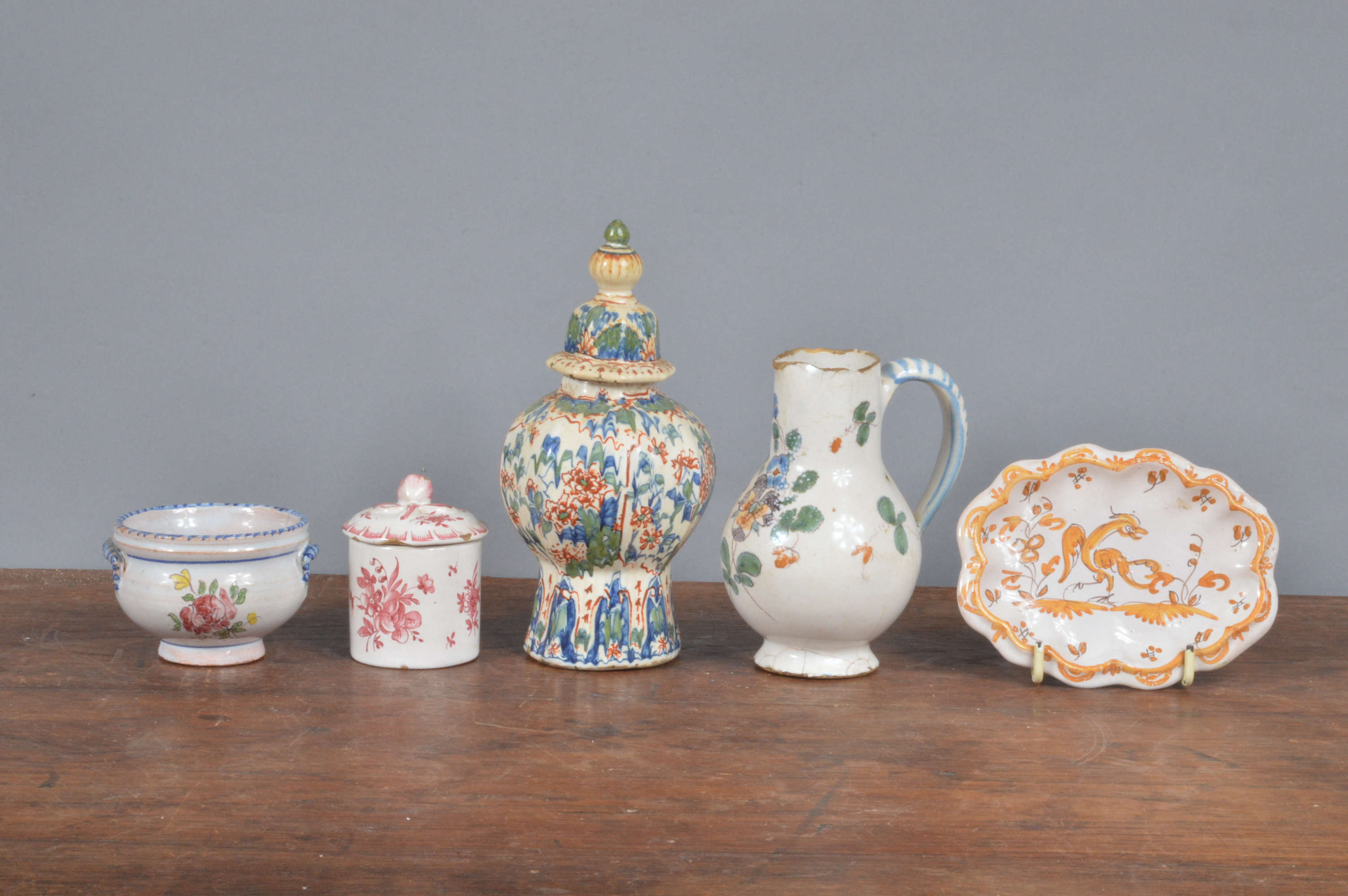 A small group of 19th century French faience, to include a covered pot, a vase and cover, a