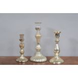 A group of three mercury glass candlesticks, each of tapering form with wide spreading foot. 19 - 27