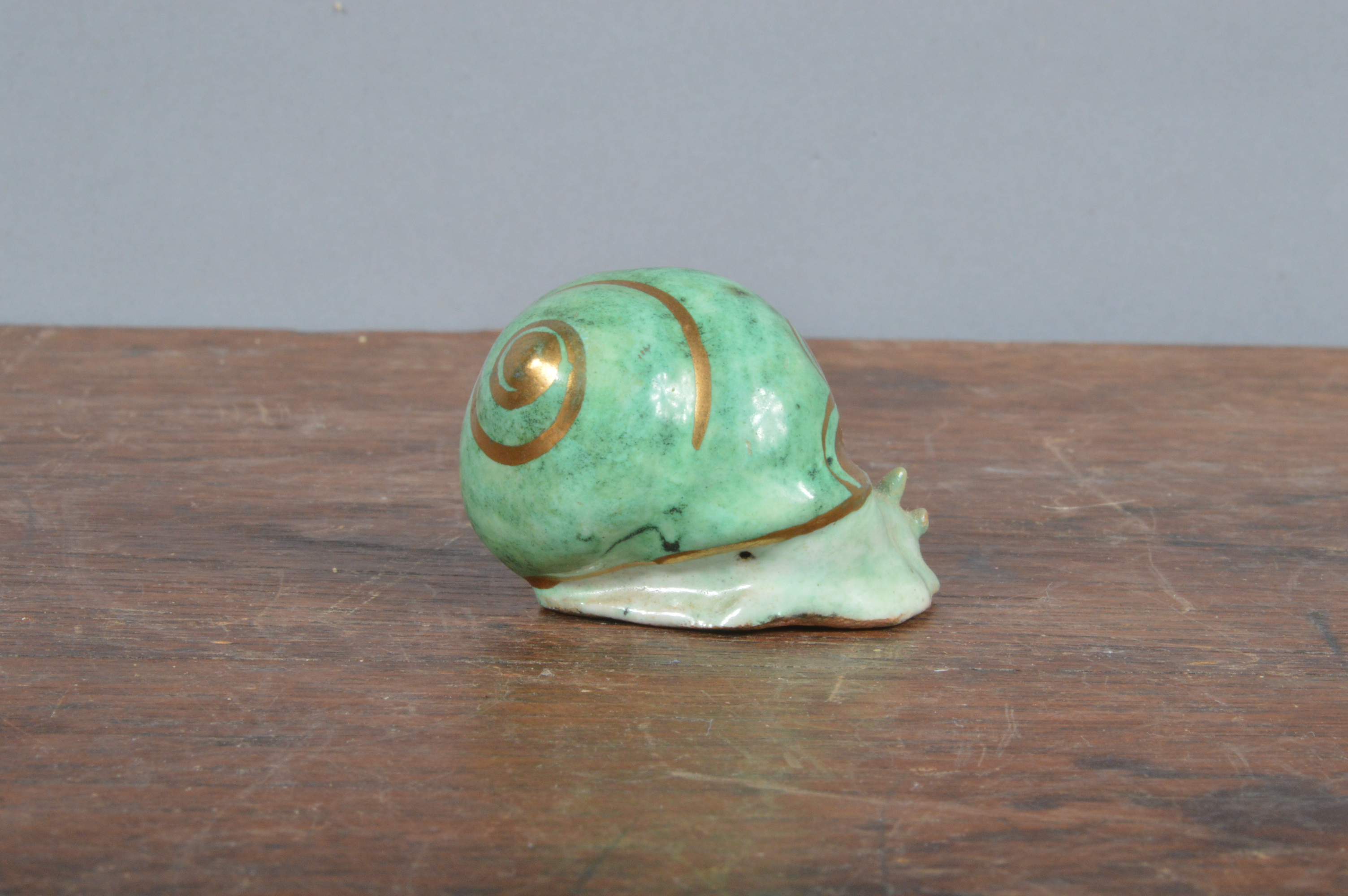 An early 20th century French Bruneau Balon Blois faience snail, green glaze with heightened gilt, - Image 2 of 3