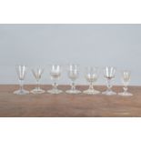 A collection of 19th century and later sherry or port glasses, including one with thistle cut