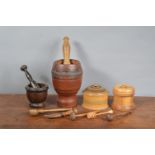 A collection of 19th century and later treen items, including two pestle and mortars, storage jars,