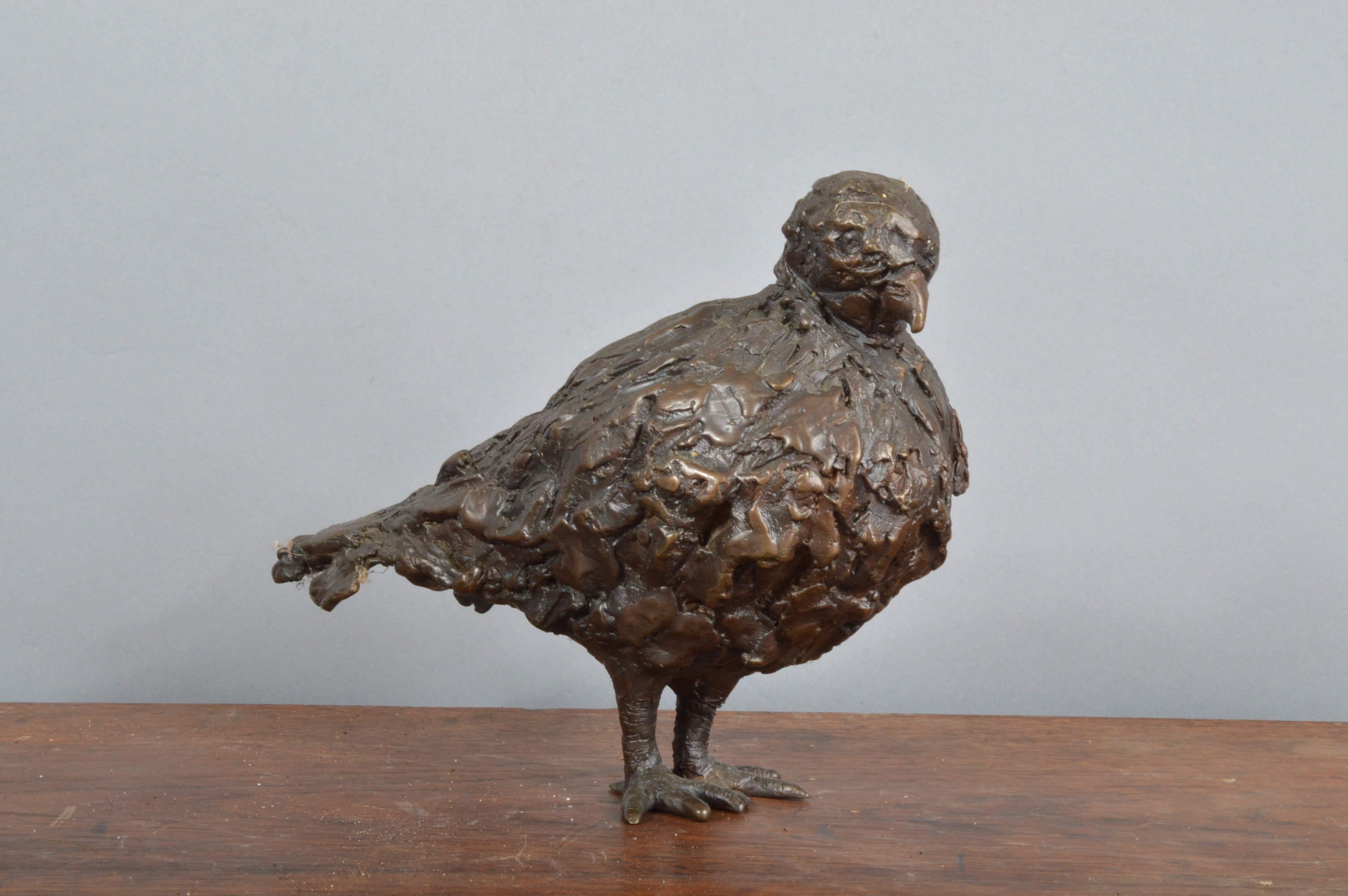 A cast bronze 20th century sculpture of a bird, incised to the underside 'C. Temin, 7 Vergez',