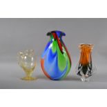 Three items of studio glass, the largest vase multi-coloured with a flared rim 31cm high, the