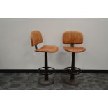 A pair of Nkuku bar/breakfast stools, fire regulation leatherette seats (stickers to the underside),