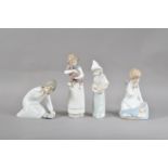 Four Lladro porcelain figurines, comprising two young girls with a kid and chicken, 22cm & 20cm