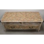 A modern upcycled low side cabinet, probably a television stand, floral wallpaper applied, with