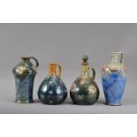 Four Royal Doulton stoneware handled bottles, one retaining the stopper, all with differing